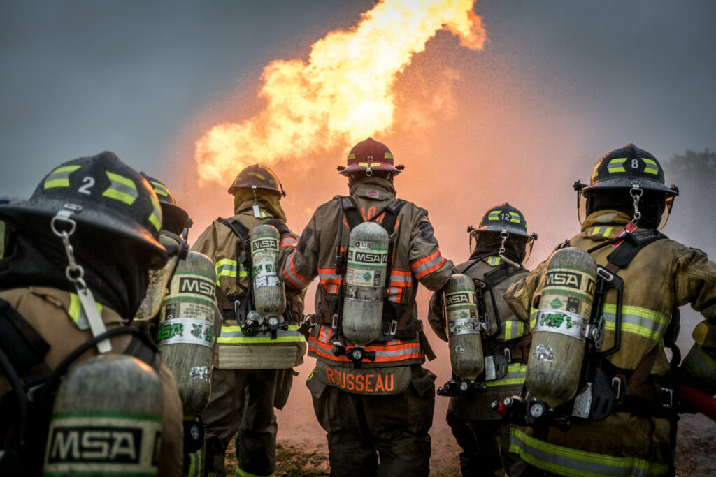 Firefighters running towards a fire