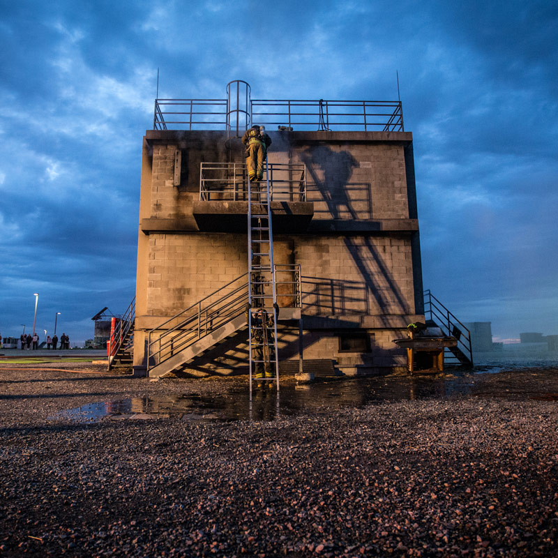 Firefighters Climbing Building