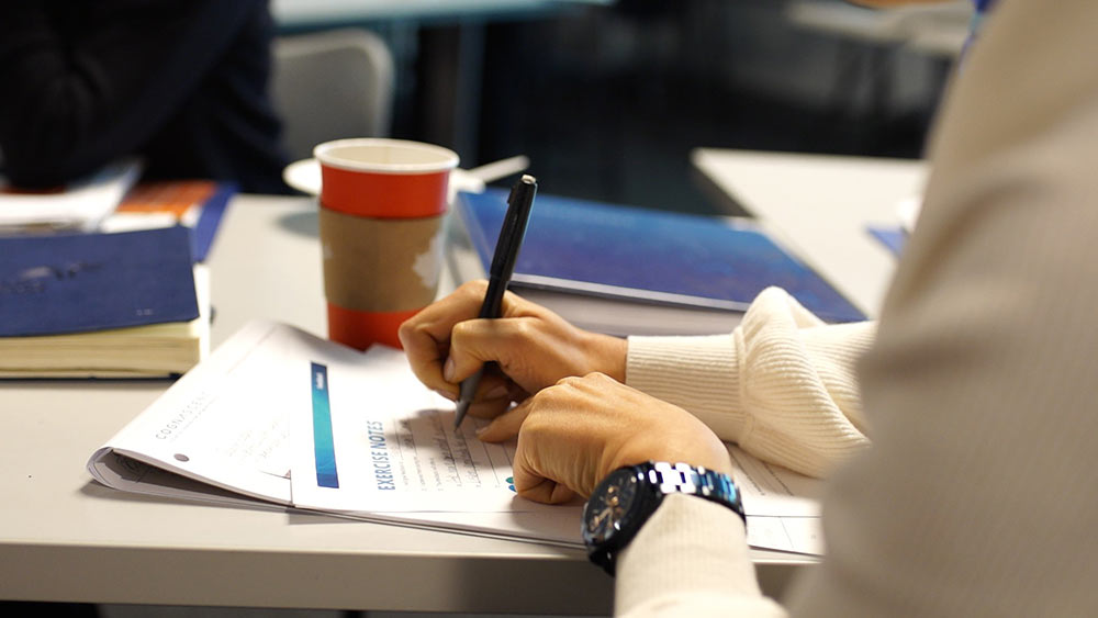Person writing on document